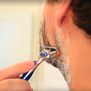 man-shaving-face-side-angle-up-close- sMan shaving with Tangie Shave Cream for a smooth and natural shave.