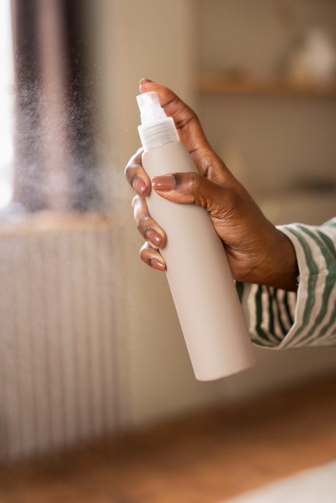 A spray bottle spraying a fine mist