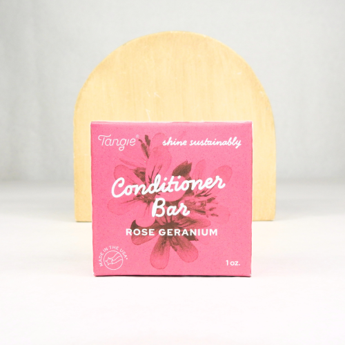 Rose Geranium Conditioner Bar by Tangie in pink box with wood background. Plastic-free solid conditioner for dry, itchy, or sensitive scalps.